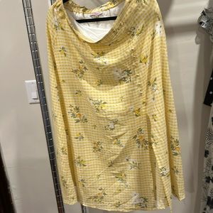Yellow with light checked background. Slit on side with buttons. Worn once